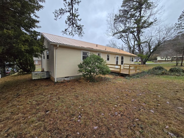 rear view of property featuring a wooden deck