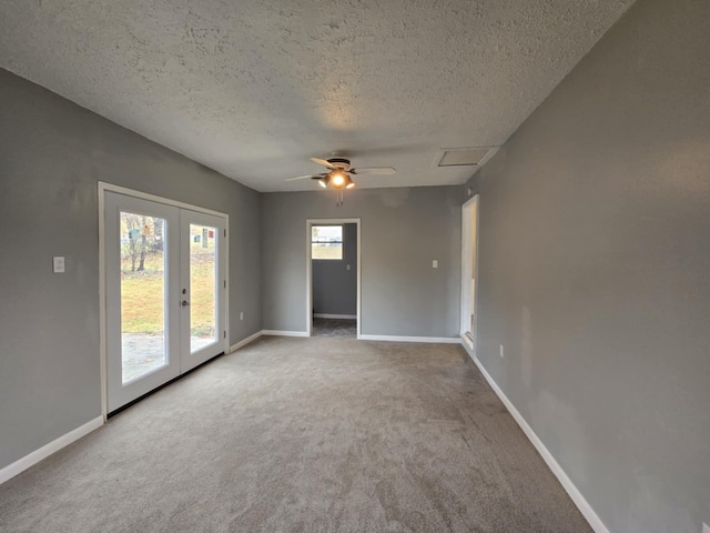 carpeted empty room with french doors, a textured ceiling, and ceiling fan