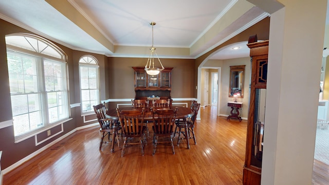 4119 Azalea Ct, Morristown, TN 37814 - dining room featuring arched walkways, light wood finished floors, baseboards, ornamental molding, and a raised ceiling
