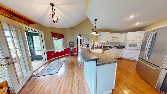 4119 Azalea Ct, Morristown, TN 37814 - kitchen featuring white appliances, a peninsula, dark countertops, arched walkways, and white cabinets