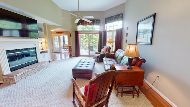 4119 Azalea Ct, Morristown, TN 37814 - living room with baseboards, a ceiling fan, arched walkways, crown molding, and a fireplace