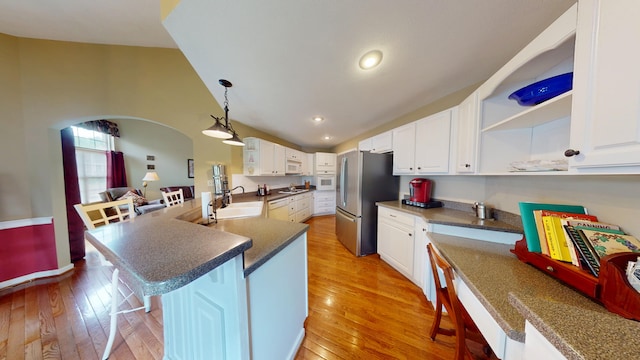 4119 Azalea Ct, Morristown, TN 37814 - kitchen featuring freestanding refrigerator, open shelves, a breakfast bar area, light wood-type flooring, and lofted ceiling