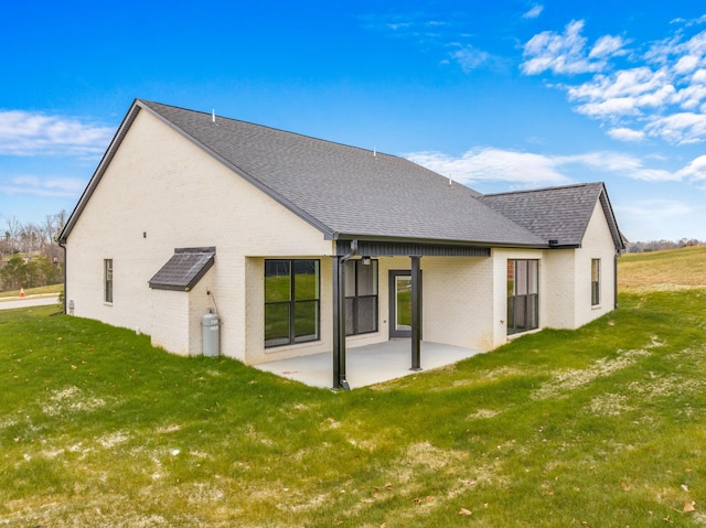 back of house featuring a patio and a lawn