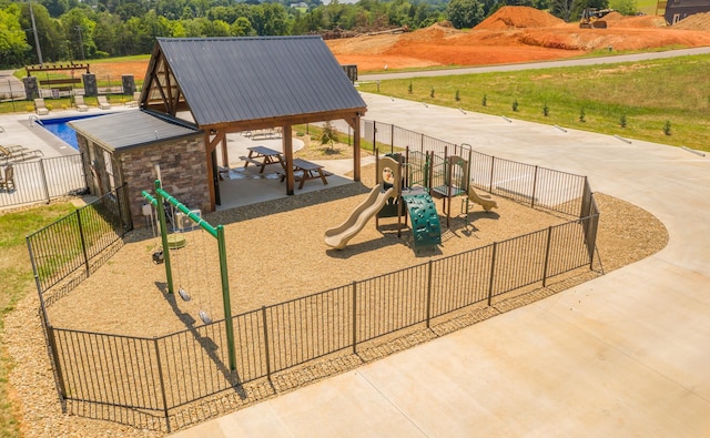 view of play area featuring a gazebo and a fenced in pool