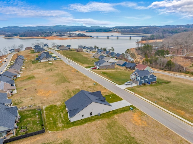 birds eye view of property with a water and mountain view