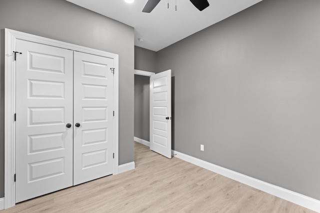 unfurnished bedroom featuring light wood-type flooring, a closet, and ceiling fan