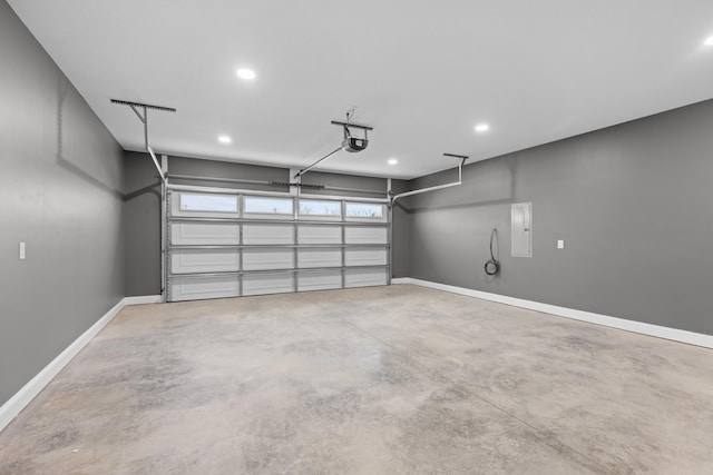 garage featuring electric panel and a garage door opener