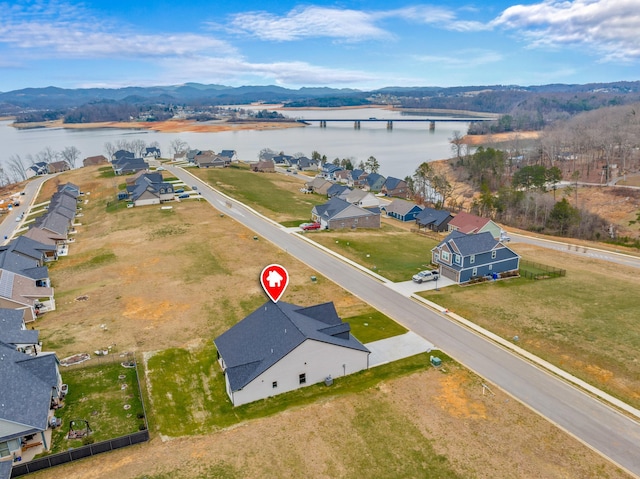 birds eye view of property featuring a water and mountain view