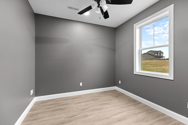 spare room featuring light hardwood / wood-style flooring and ceiling fan