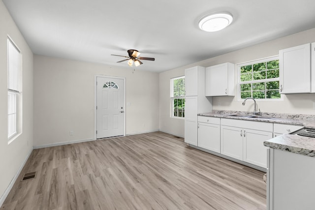 329 Shady Glen Ln, Rutledge, TN 37861 - kitchen featuring a ceiling fan, light wood-type flooring, white cabinets, and light stone countertops
