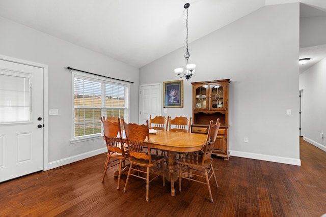 dining area featuring dark hardwood / wood-style flooring, lofted ceiling, and a notable chandelier