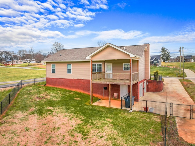 back of property with a yard and a patio area