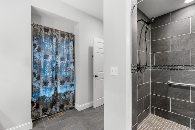 bathroom featuring tile patterned floors and tiled shower