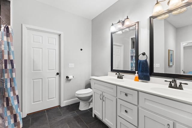 bathroom with tile patterned floors, vanity, and toilet