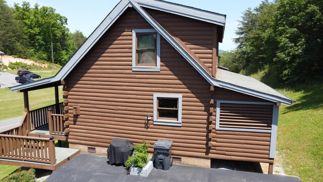 view of home's exterior with crawl space and log exterior