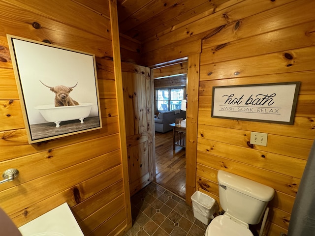 bathroom featuring wood ceiling, wood walls, and toilet