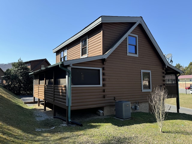 view of side of home with a yard, cooling unit, and log siding