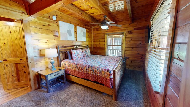 carpeted bedroom with wooden walls, wood ceiling, and beam ceiling
