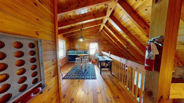 interior space featuring wood walls, lofted ceiling with beams, wood ceiling, and hardwood / wood-style flooring