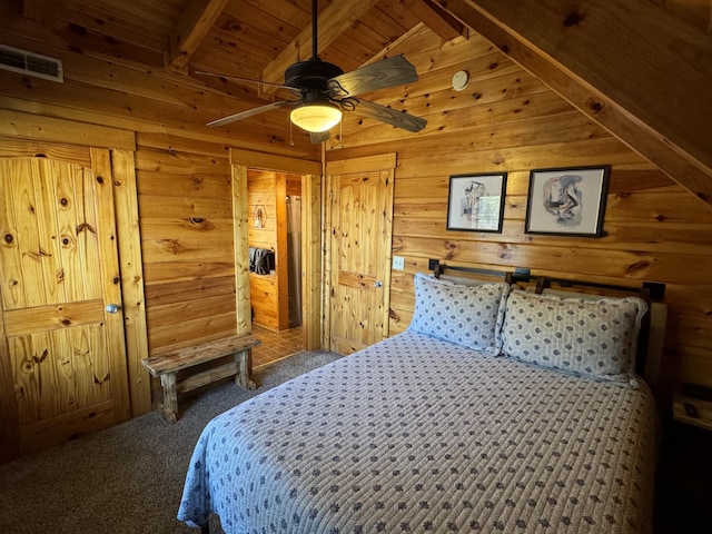 bedroom featuring visible vents, lofted ceiling with beams, wood ceiling, carpet flooring, and wooden walls