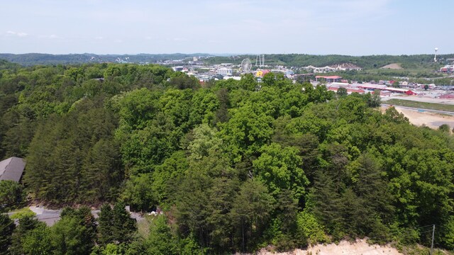 birds eye view of property featuring a view of trees