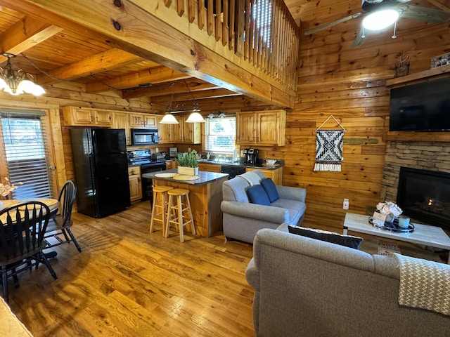 living room featuring a stone fireplace, wood walls, wooden ceiling, and light wood-style floors