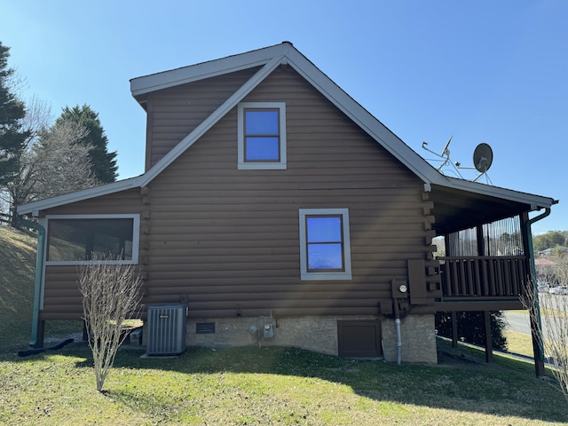 view of property exterior with log exterior, central AC, a yard, and crawl space