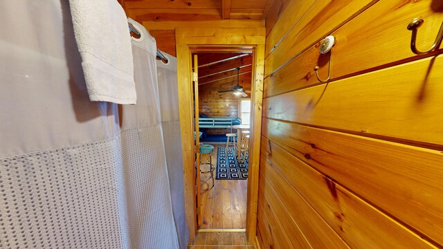 hall featuring wooden walls