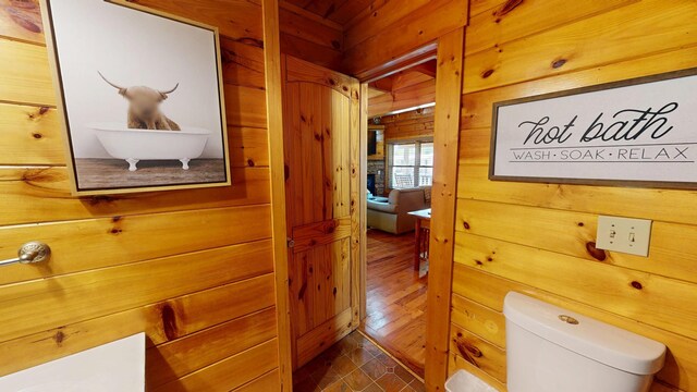 dining room featuring visible vents, wood walls, vaulted ceiling with beams, wood ceiling, and a ceiling fan
