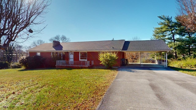 ranch-style house with a carport and a front lawn