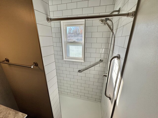 bathroom with tiled shower