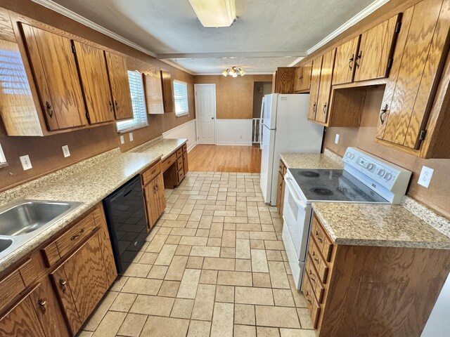 kitchen with sink, white appliances, and crown molding