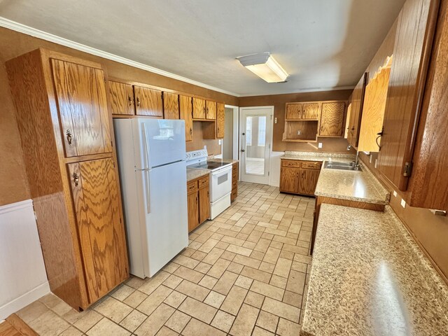 kitchen featuring sink, white appliances, and ornamental molding