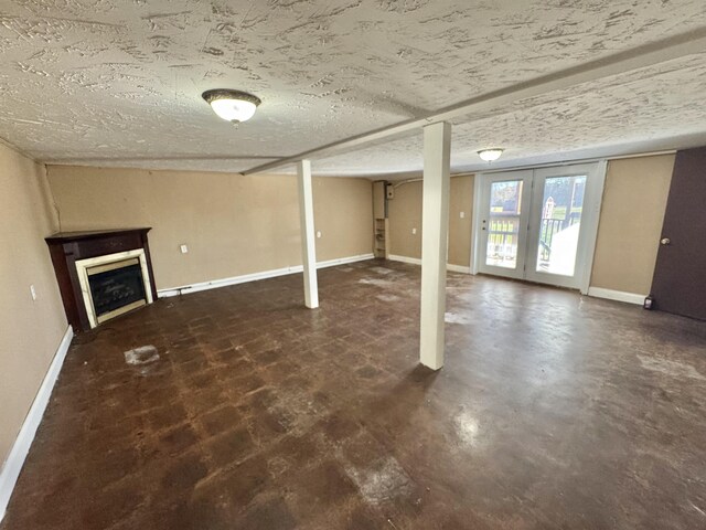 basement with a textured ceiling and french doors