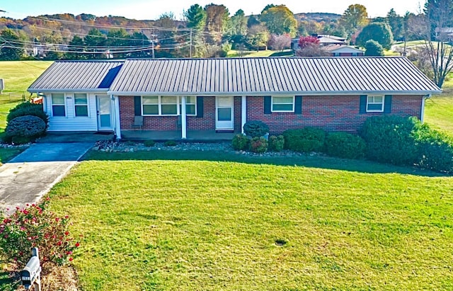 ranch-style house with a front yard and covered porch