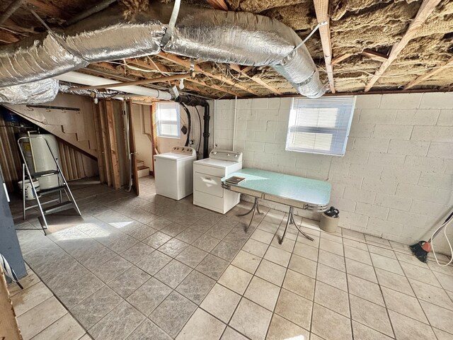 basement featuring a wealth of natural light and washing machine and clothes dryer