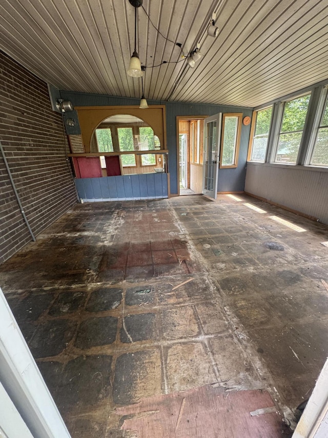 unfurnished sunroom with plenty of natural light