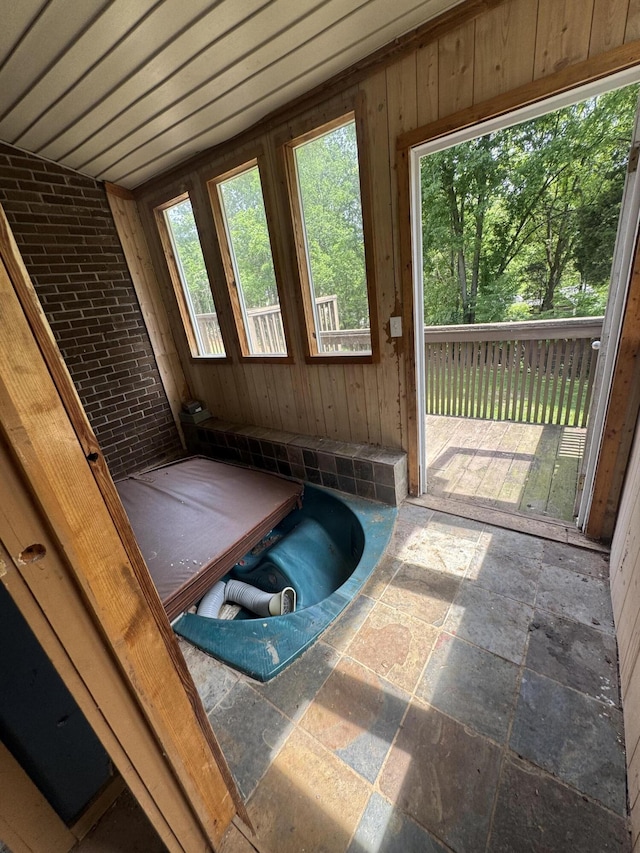 unfurnished sunroom with a jacuzzi