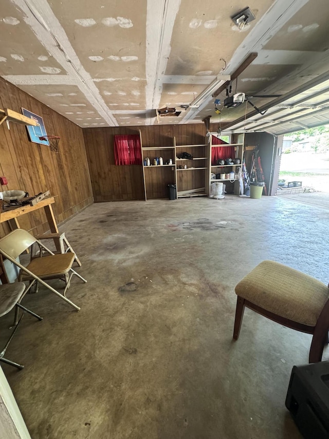 garage with wooden walls and a garage door opener