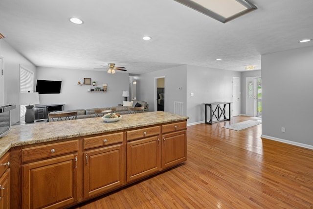 4705 E Hampton Blvd, Morristown, TN 37813 - kitchen featuring open floor plan, light wood-style floors, ceiling fan, recessed lighting, and brown cabinets