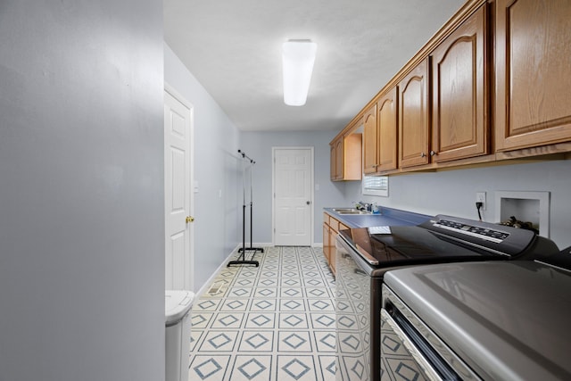 4705 E Hampton Blvd, Morristown, TN 37813 - washroom featuring washer and clothes dryer, baseboards, and cabinet space