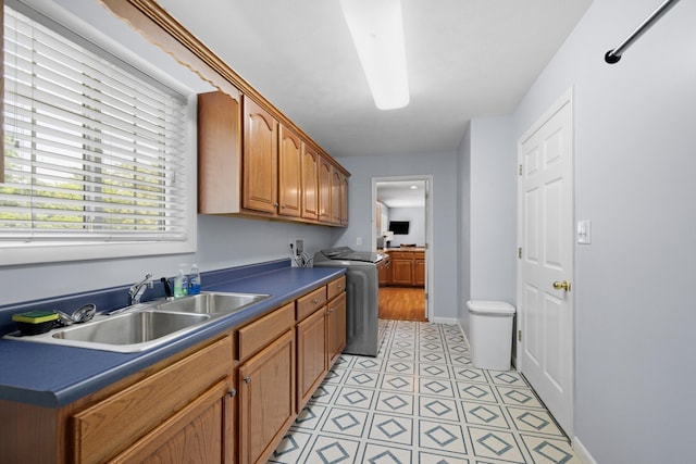 4705 E Hampton Blvd, Morristown, TN 37813 - kitchen featuring a sink, dark countertops, brown cabinets, light tile patterned flooring, and baseboards