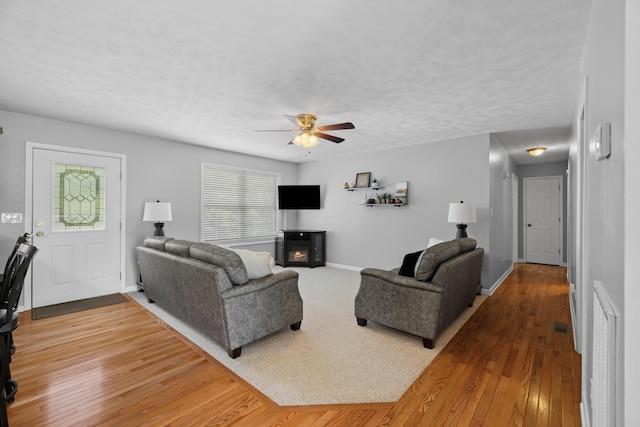 4705 E Hampton Blvd, Morristown, TN 37813 - living room featuring a ceiling fan, wood-type flooring, baseboards, and a textured ceiling