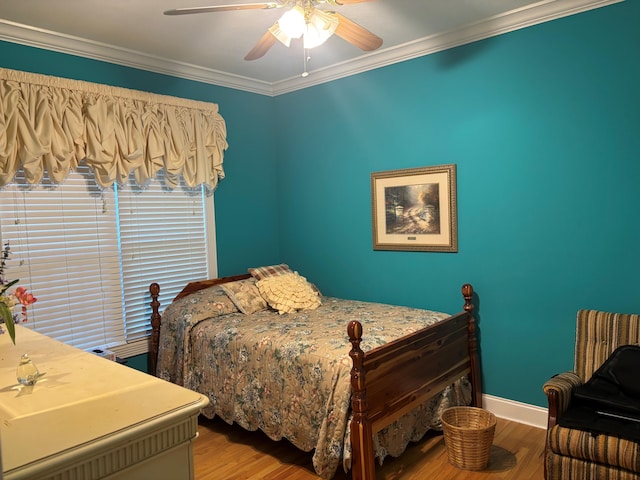 bedroom featuring wood finished floors, ornamental molding, ceiling fan, and baseboards