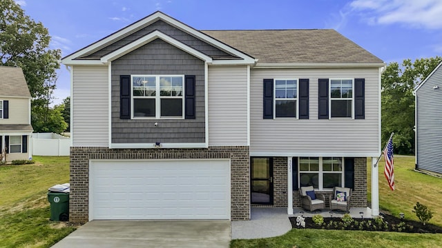 5021 Cottonseed Way, Morristown, TN 37813 - view of front facade featuring brick siding, a garage, concrete driveway, and covered porch