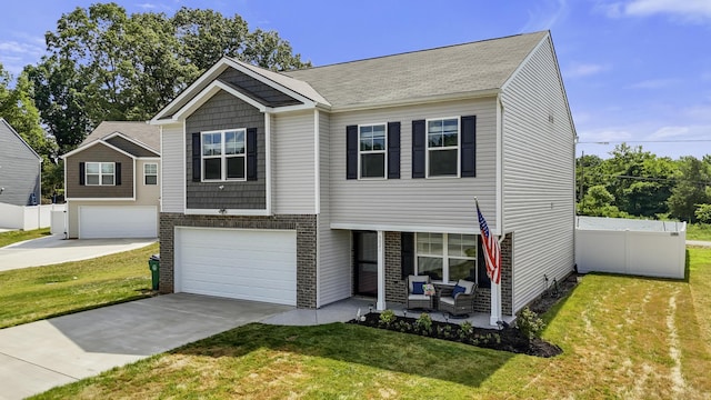 5021 Cottonseed Way, Morristown, TN 37813 - view of front of property with concrete driveway, a garage, brick siding, and outdoor lounge area