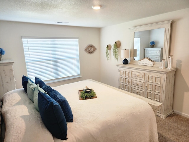 bedroom with carpet floors, baseboards, and visible vents
