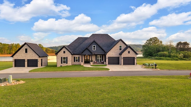 french country inspired facade with a garage, a front lawn, brick siding, and driveway