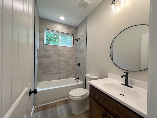 553 Sequoyah Dr, Morristown, TN 37813 - bathroom featuring vanity, wood finished floors, toilet, and bathtub / shower combination