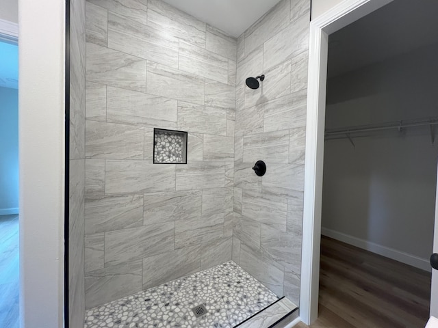 553 Sequoyah Dr, Morristown, TN 37813 - full bathroom featuring a stall shower, wood finished floors, baseboards, and a spacious closet